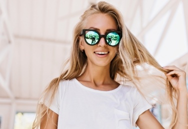 Smiling blonde woman wearing sunglasses