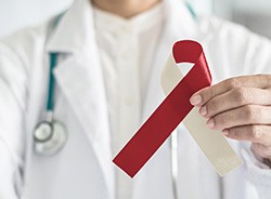Man holding an oral cancer ribbon