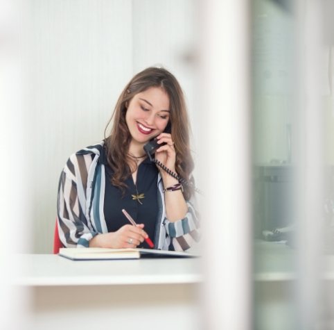 Woman talking on phone about BlueCross BlueShield dental insurance in Hoover