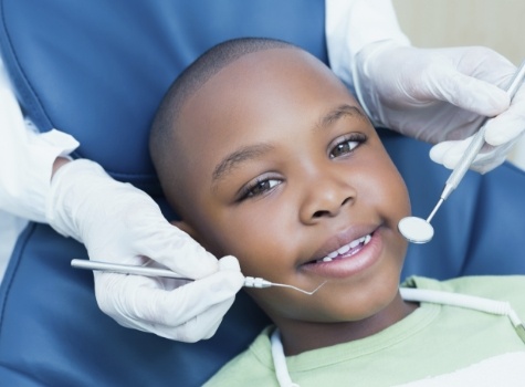 Young boy smiling during children's dental checkup