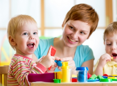 Mother with two young kids in children's dentistry office in Hoover