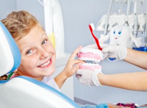 Young boy grinning in dental chair