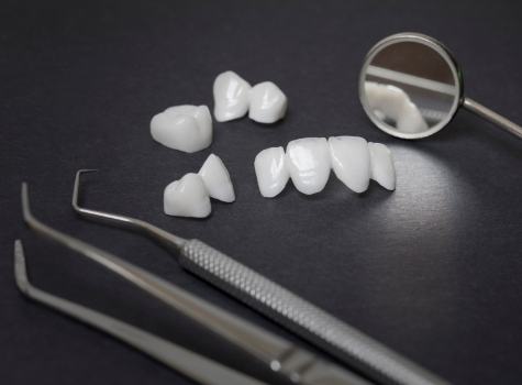 Several metal free dental crowns against black background