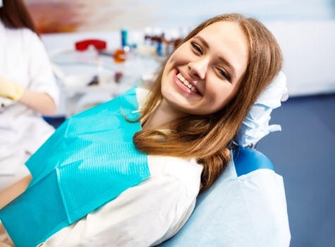 Young woman grinning in dental chair