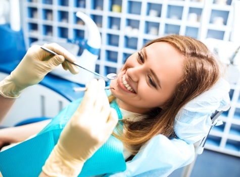 Young woman grinning right before dental exam