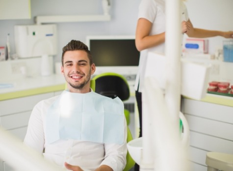 Young smiling man sitting in dental chair