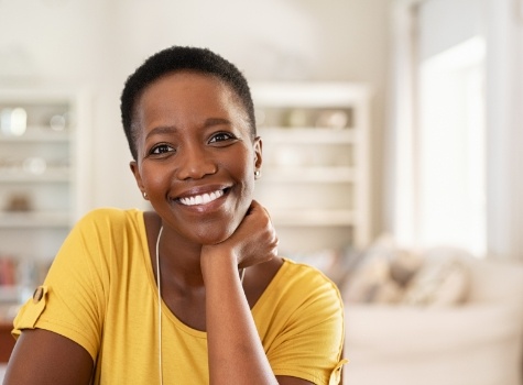 Smiling woman in yellow blouse