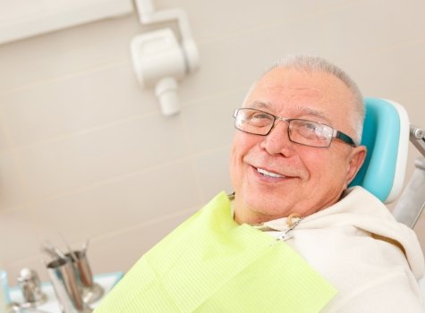 Senior man smiling in dental chair