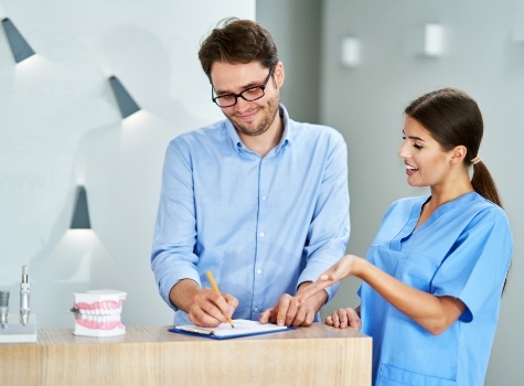 Dental team member discussing cost of dentures with a patient