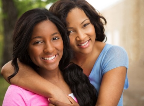 Mother and daughter hugging