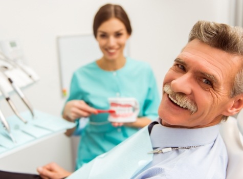 Smiling senior man in dental chair