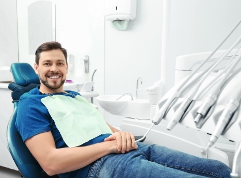 Man smiling while leaning back in dental chair