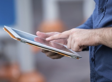 Person typing on tablet