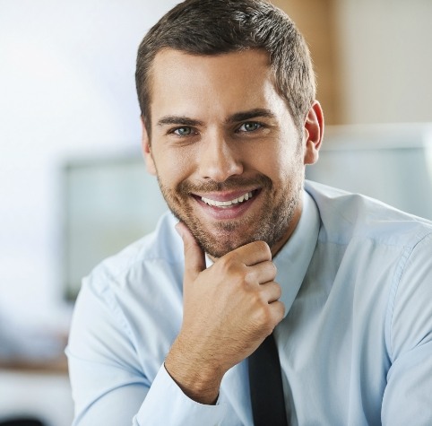 Man in dress shirt and tie smiling after gum disease treatment in Hoover