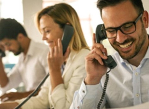 Three office workers talking on the phone