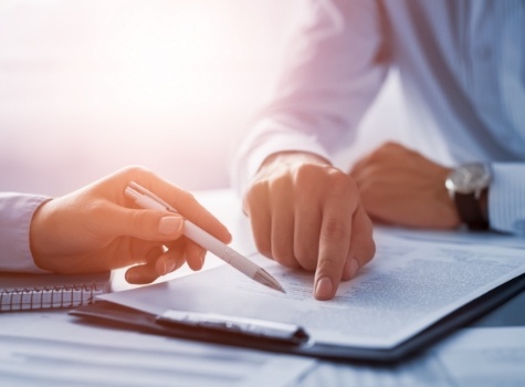 Two people looking at paper on clipboard