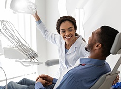 Dentist smiling at patient during visit