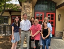 Doctor Moulton with his family in front of a restaurant