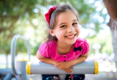 Young girl smiling at outdoor playground