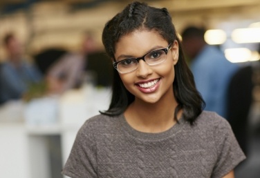 Young woman with glasses smiling