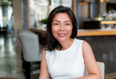 Smiling woman sitting at table in coffee shop