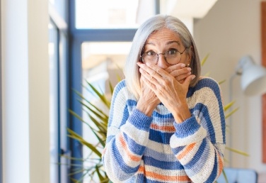 Woman covering her mouth with her hands