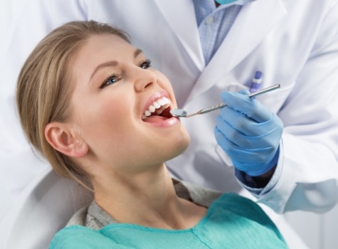 Woman receiving dental exam during preventive dentistry visit