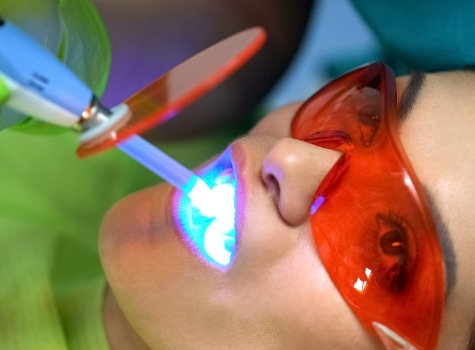 Woman in dental chair giving thumbs up