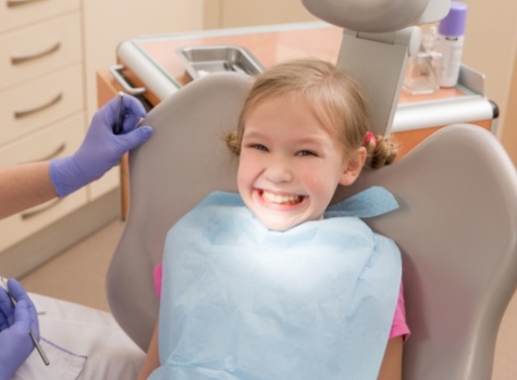 Young girl grinning in dental chair