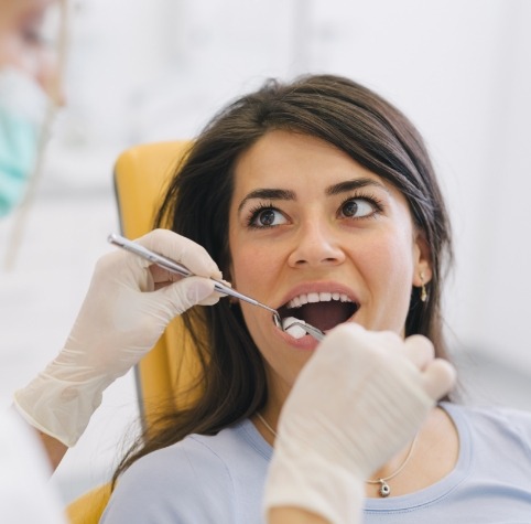 Dental patient smiling before tooth extractions in Hoover