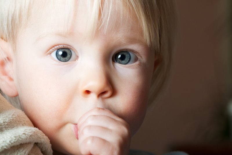 Closeup of child sucking their thumb