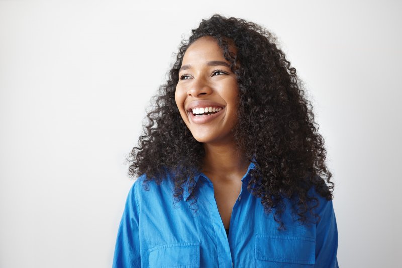 woman smiling about the benefits of dentures in Birmingham