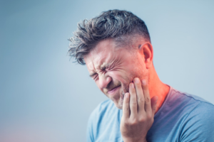 a patient suffering from intense oral pain 