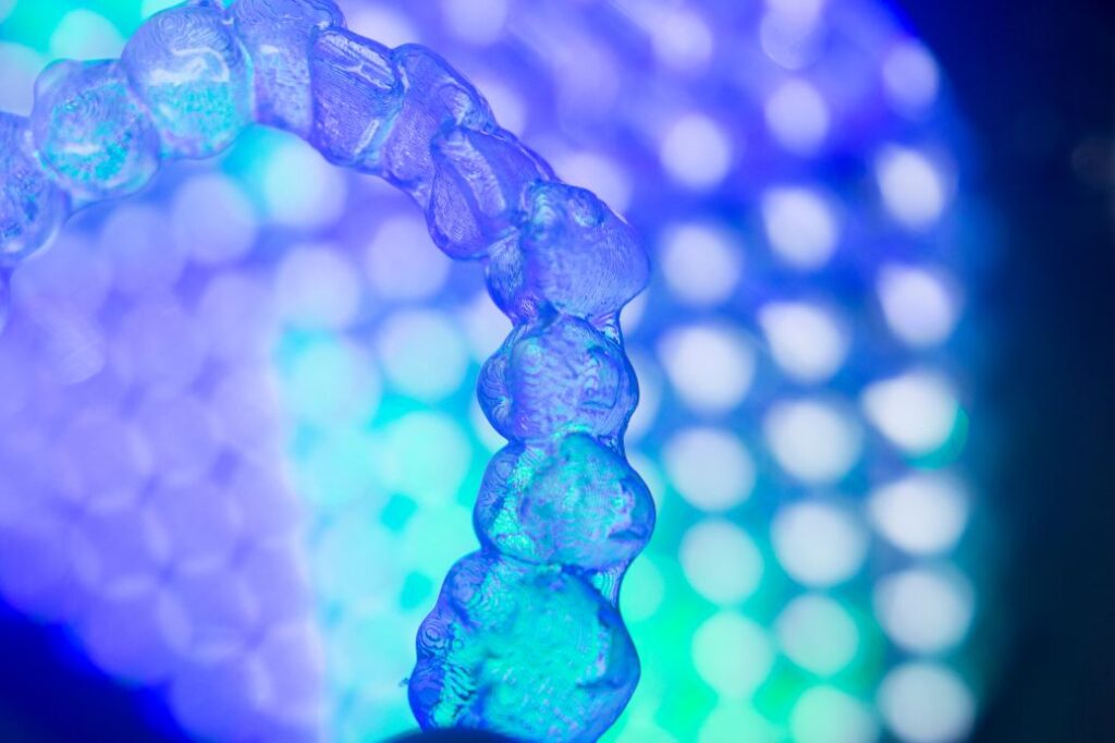 A blue tinted SureSmile aligner